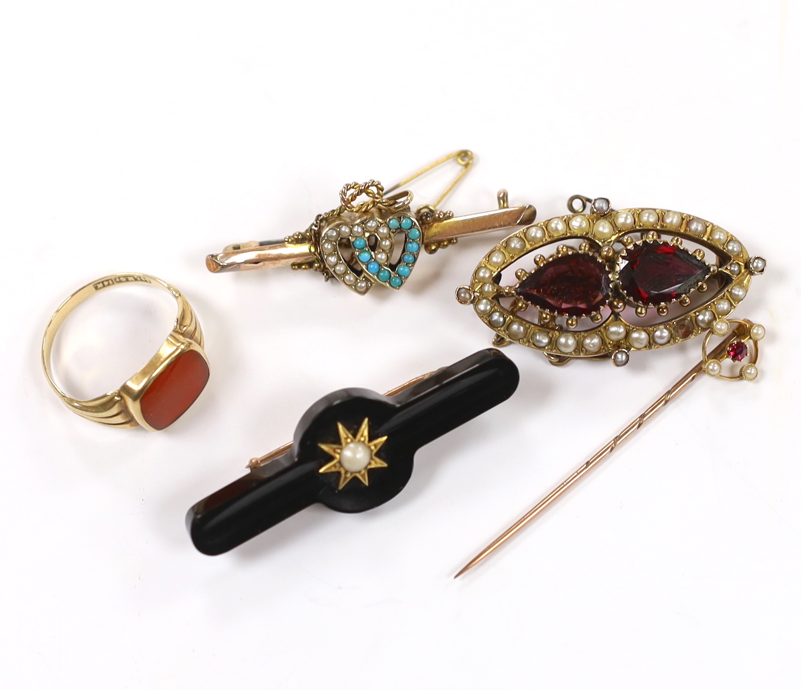 A 14k and carnelian set signet ring, size R/S, 3.1 grams, a Victorian yellow metal, two stone garnet and split pearl cluster set brooch, two other 9ct and gem set bar brooches including twin hearts and a 15ct and gem set